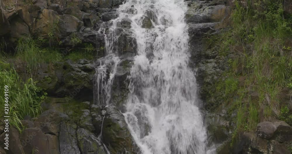 Waterfall along a rocky cliff. Waterfall along a rocky cliff.