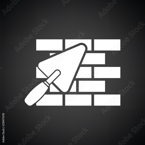 Icon of brick wall with trowel