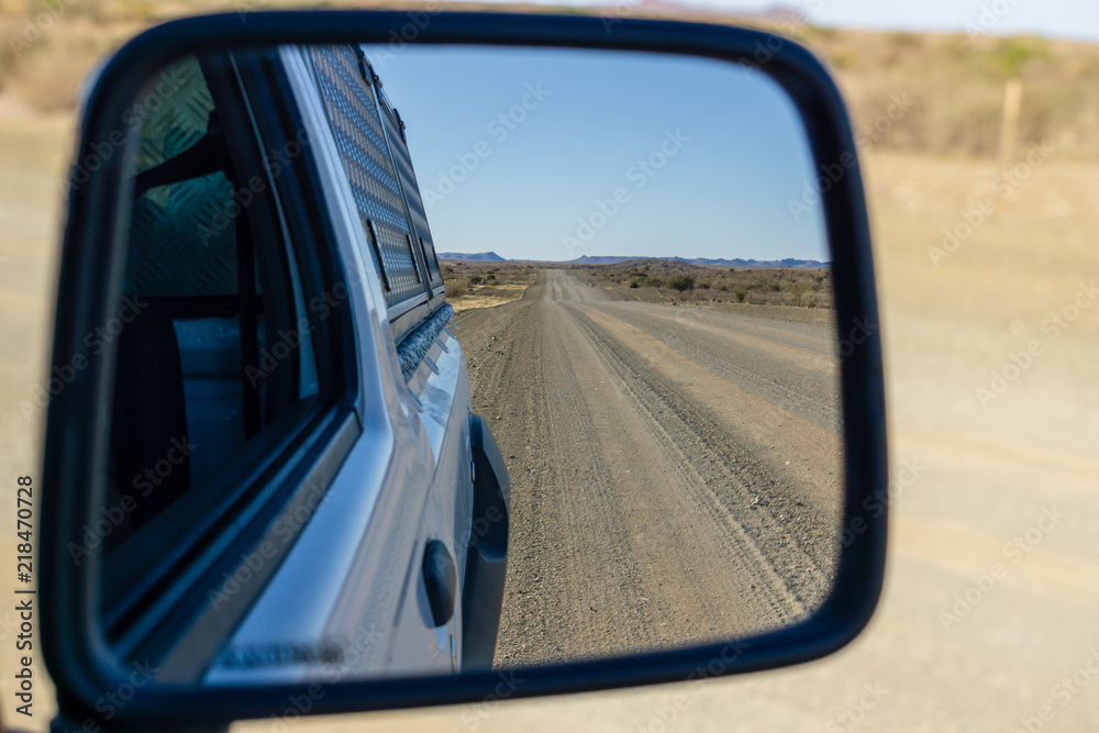 empty road in the desert - view in the car mirror namibia