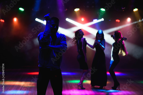 party, holidays, celebration, nightlife and people concept - group of happy friends dancing in night club