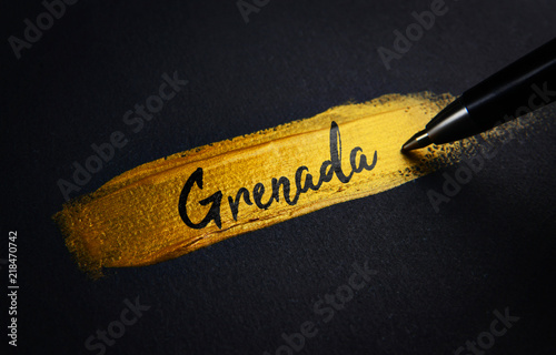 Grenada Handwriting Text on Golden Paint Brush Stroke
