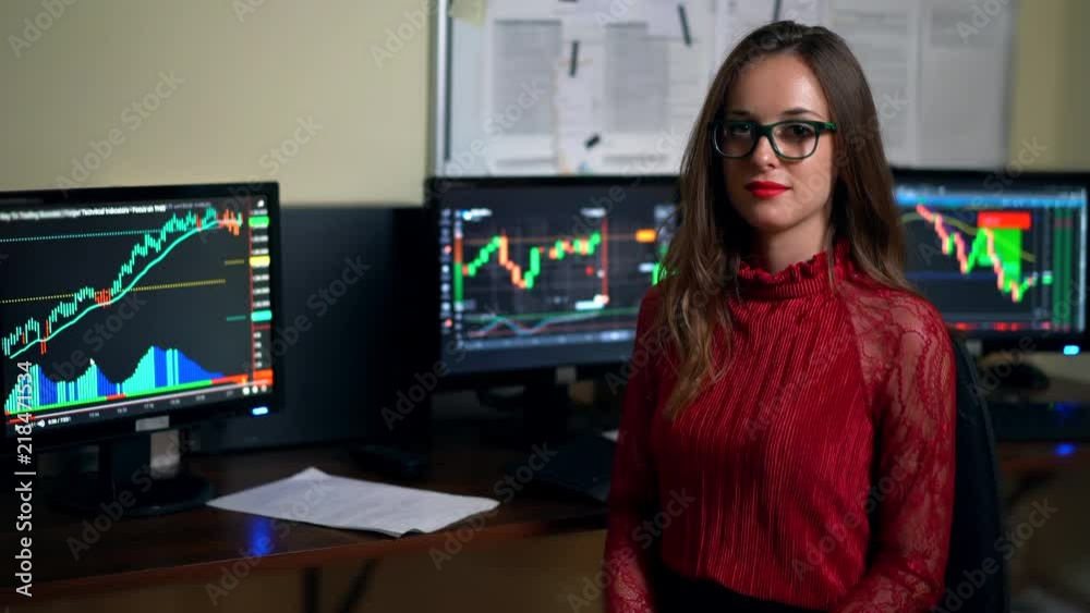 Financial advisor on the background of monitors full of trade diagrams.Company assistent working in office with trading profits. Shot in 4K (UHD). Financial advisor on the background of monitors full of trade diagrams.Company assistent working in office with trading profits. Shot in 4K (UHD).