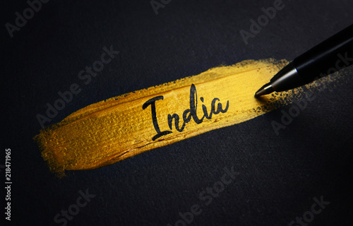 India Handwriting Text on Golden Paint Brush Stroke