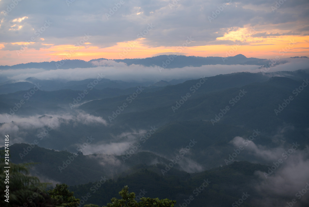 Landscape view of beautiful mist on top of mountains on sunrise time at Gunungsilepat mountains, Yala province south of Thailand.