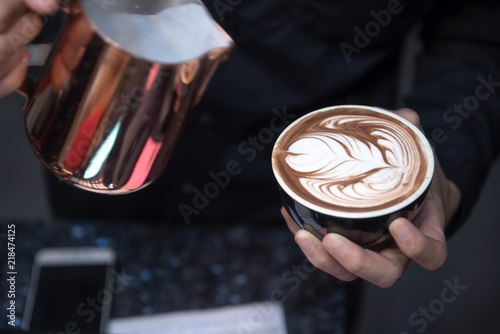 Coffee Latte Barista making pattern in a cup of coffee shop