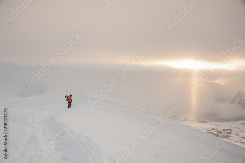 Snowboarder on the gorgeous winter sunset in mountains. Gudauri, Georgia