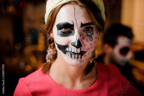 Redhead girl with adorable Halloween makeup on the party