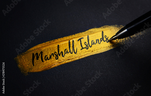 Marshall Islands Handwriting Text on Golden Paint Brush Stroke