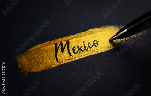 Mexico Handwriting Text on Golden Paint Brush Stroke