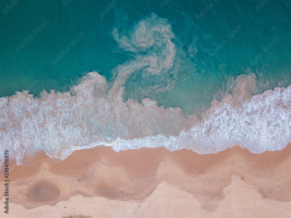 aerialy of beach and sea meeting each other