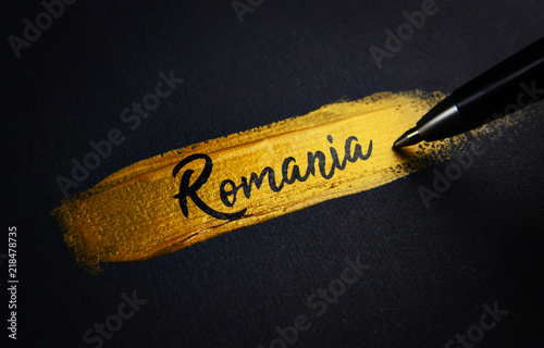Romania Handwriting Text on Golden Paint Brush Stroke