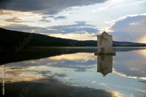 A solitary windmill emerges from Orbetello   s lagoon  in Tuscany. It is the so-called Spanish Windmill  an untamed stone Don Quixote that guards the town.