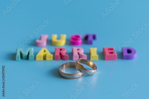 Multicolored inscription just married on a blue background photo