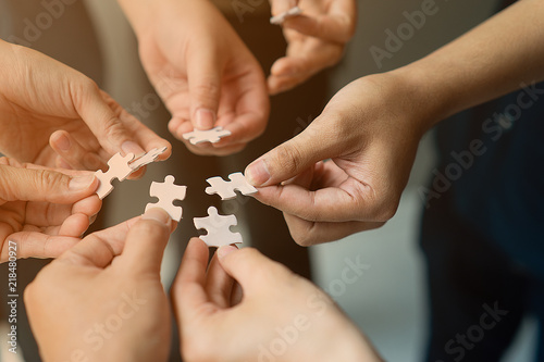 hands with jigsaw join together as team photo