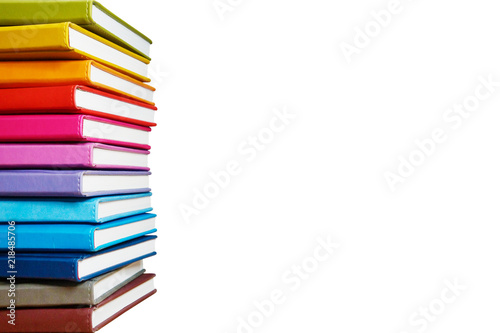 Books. A lot of books with bright covers in one pile isolated on white background. Place for text. Design element, paper and leather texture. Colorful books on the shelf, close up