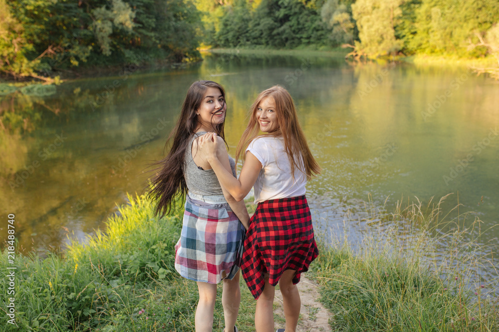 happy young awesome women spending time near the lake. travel and tourism concept happy young awesome women spending time near the lake. travel and tourism concept