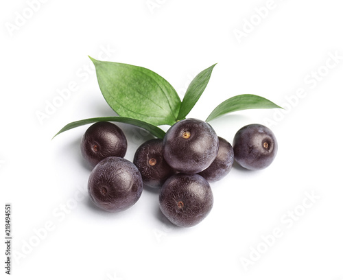 Fresh acai berries with leaves on white background