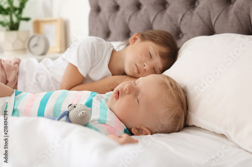 Little children sleeping in bed at home