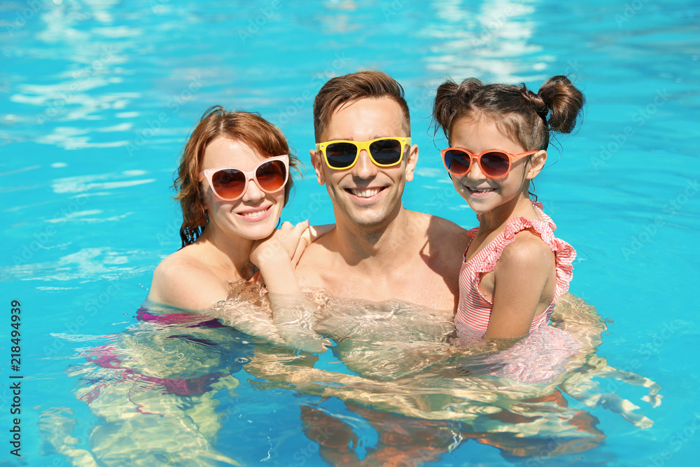 Happy family in swimming pool at resort Happy family in swimming pool at resort