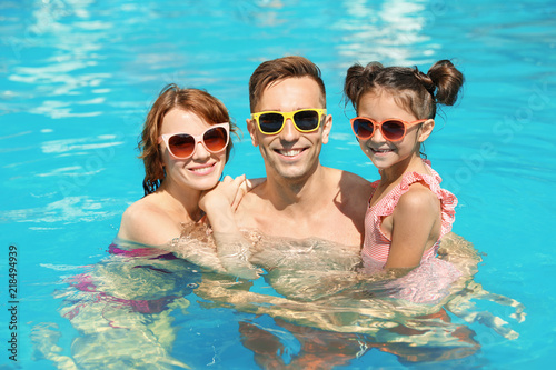 Happy family in swimming pool at resort © New Africa