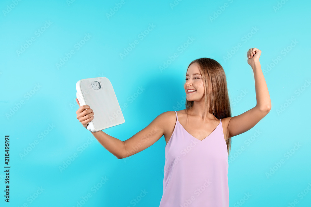 Slim woman with scale on color background. Healthy diet Slim woman with scale on color background. Healthy diet
