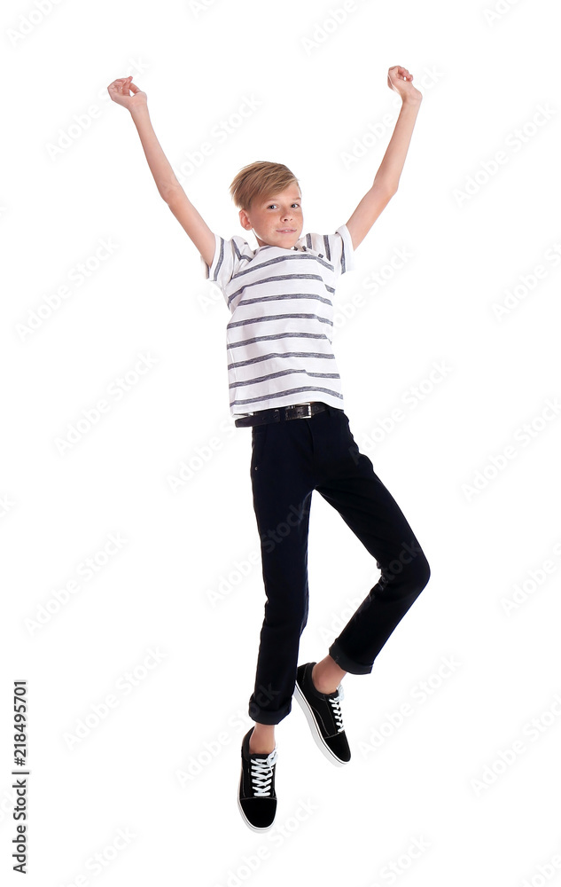 Portrait of young boy jumping on white background