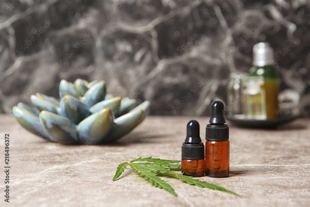 Composition with hemp lotion on grey table. Space for text Composition with hemp lotion on grey table. Space for text