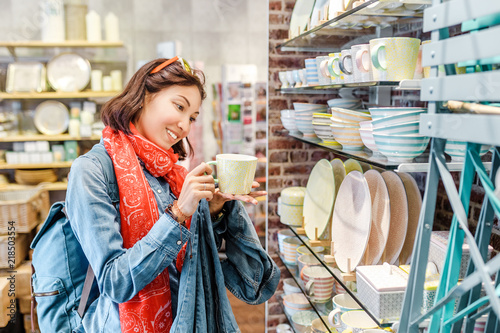 Asian girl shopping for kitchenware in retail store photo