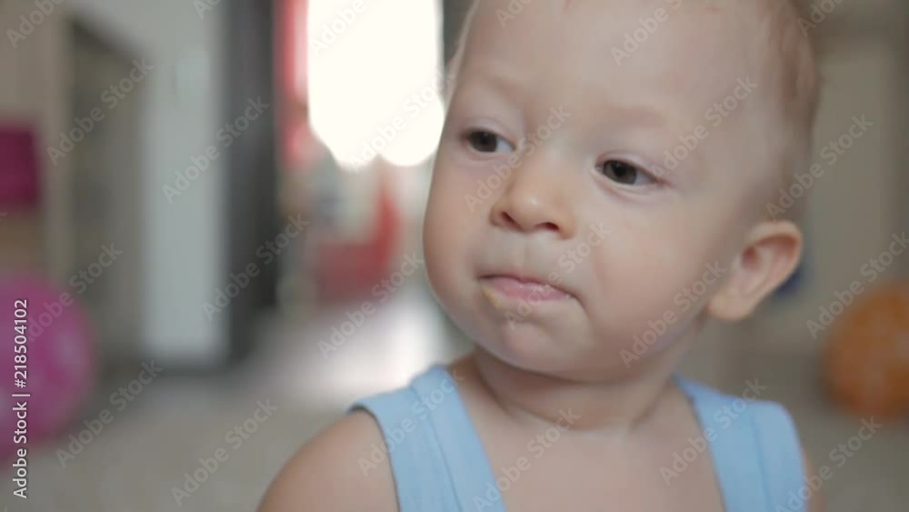 Close up of baby's face while it smiles and laughs. A cute little baby is looking into the camera. Close up of baby's face while it smiles and laughs. A cute little baby is looking into the camera.