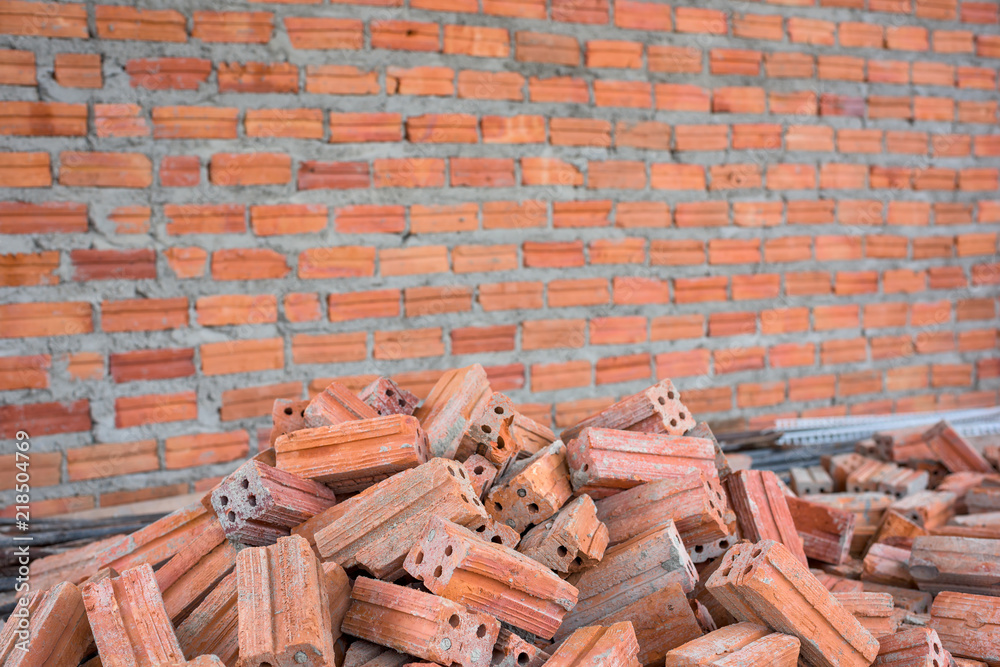 Pile of bricks with wall texture background.