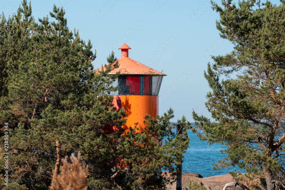 Small orange lighthouse on island
