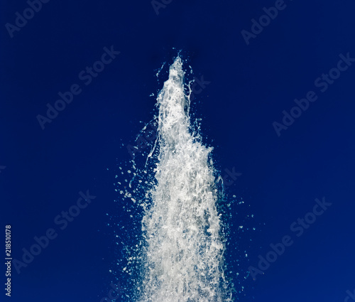 Water fountain against the dark blue sky