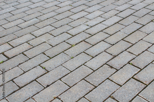 Sidewalk of cobblestones. View diagonally. Close-up. Background. Texture.