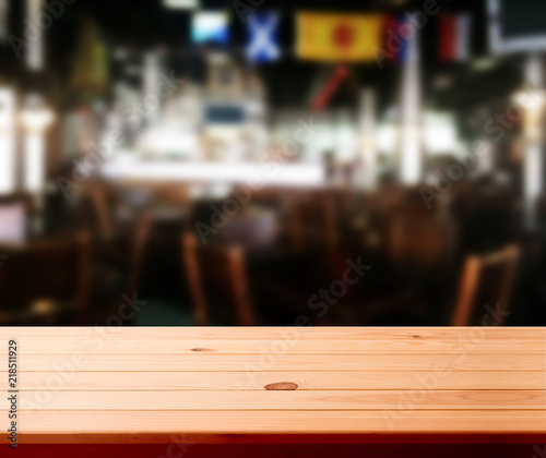 Wood table with blured background cafe , for your photo montage or product display. Space for placing items on the table. © missty