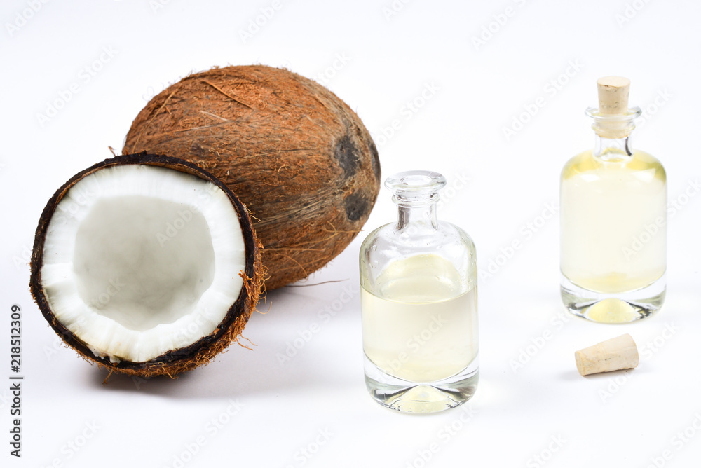 Natural coconut oil in bottles on white background. Natural coconut oil in bottles on white background.