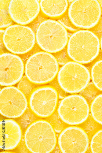 A slices of fresh juicy yellow lemons.  Texture background, pattern.