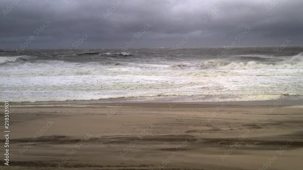 Stormy weather at the beach shows moody clouds and choppy waves. Stormy weather at the beach shows moody clouds and choppy waves.