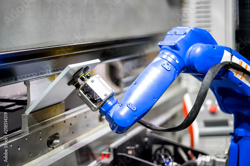 Hand robot working automatic cutting and bending metal sheet by high precision metal sheet bending machine, cnc control metal sheet bending machine in factory