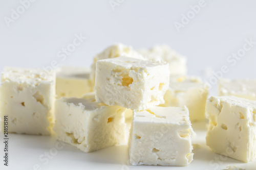Feta cheese cubes isolated on white background