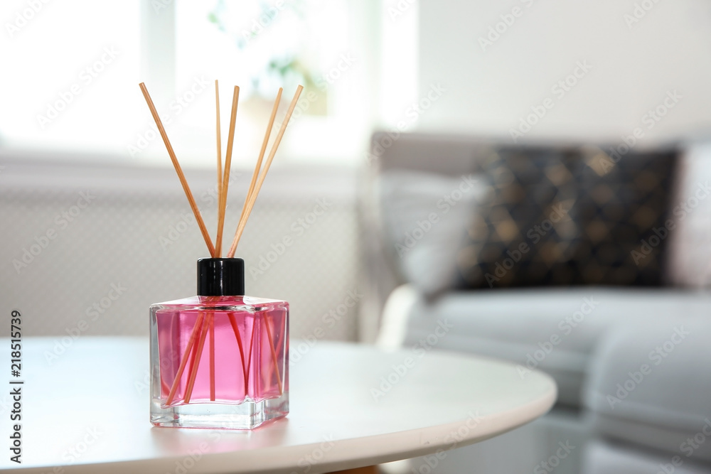 Aromatic reed air freshener on table indoors
