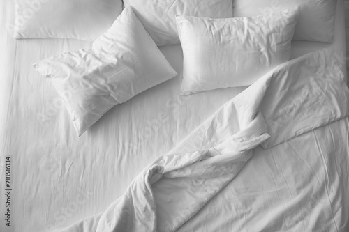 Soft pillows on comfortable bed, top view photo