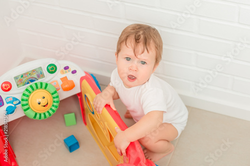 Cute little baby boy playing with developping toy photo
