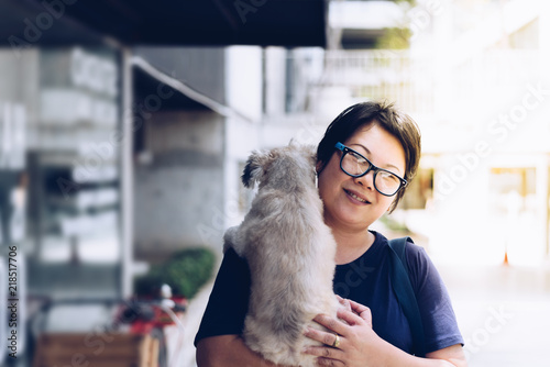 Asian woman hugging dog so cute at coffee shop