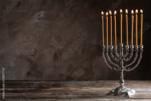 Hanukkah menorah on table against grey background