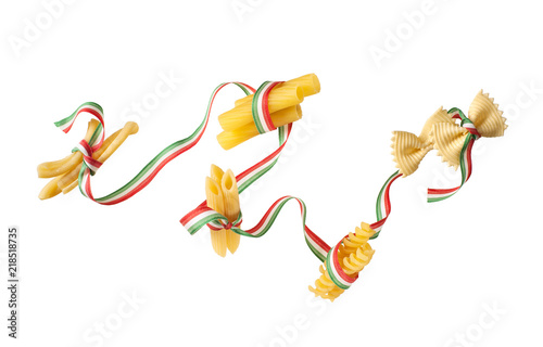 Pasta of various types wound with tricolor ribbon, isolated on white background