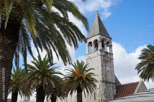 Saint Dominican convent and church in Trogir, Croatia, surrounded by palm trees 