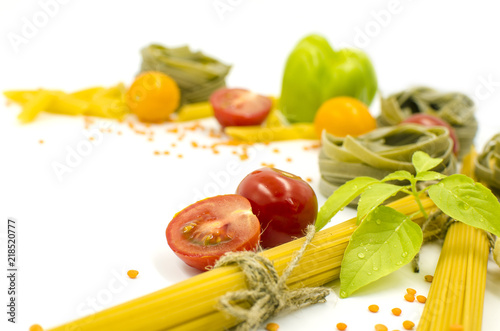 Pasta, spaghetti, tomatoes, basil are on a white background