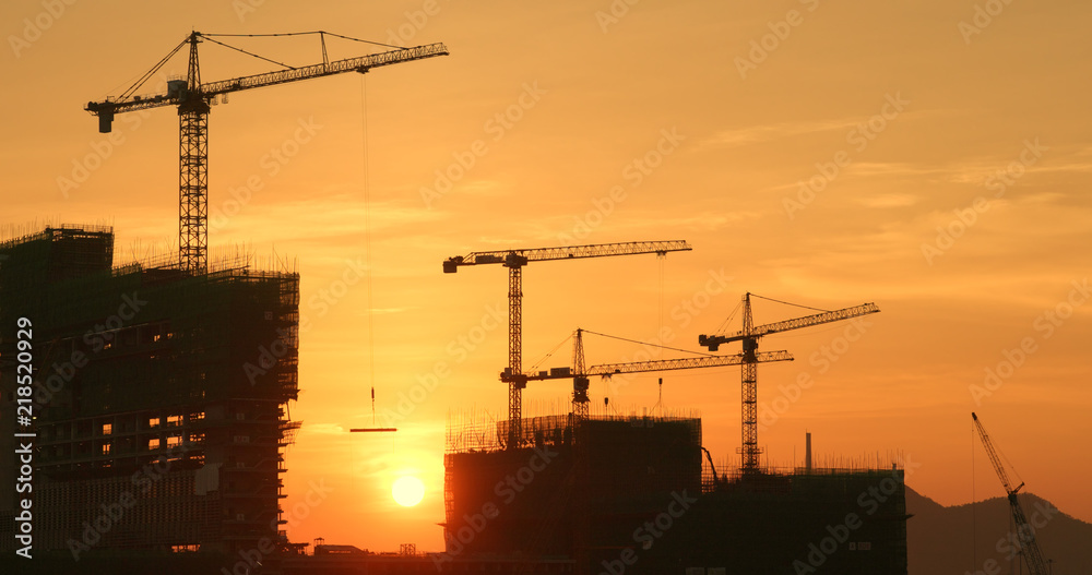 Silhouette of the construction site on sunset