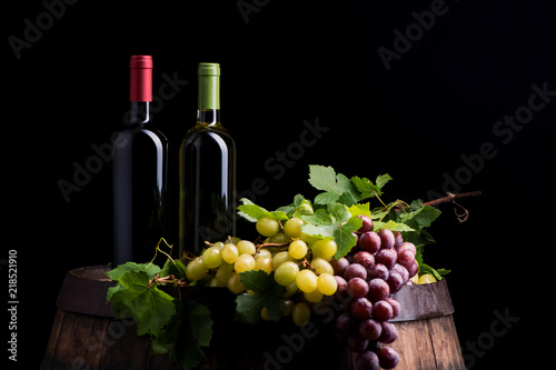 Two bottles of wine on dark background