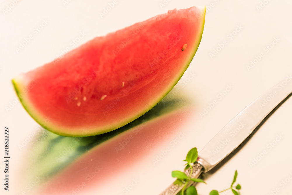 Red watermelon with its reflection in the shiny surface Red watermelon with its reflection in the shiny surface